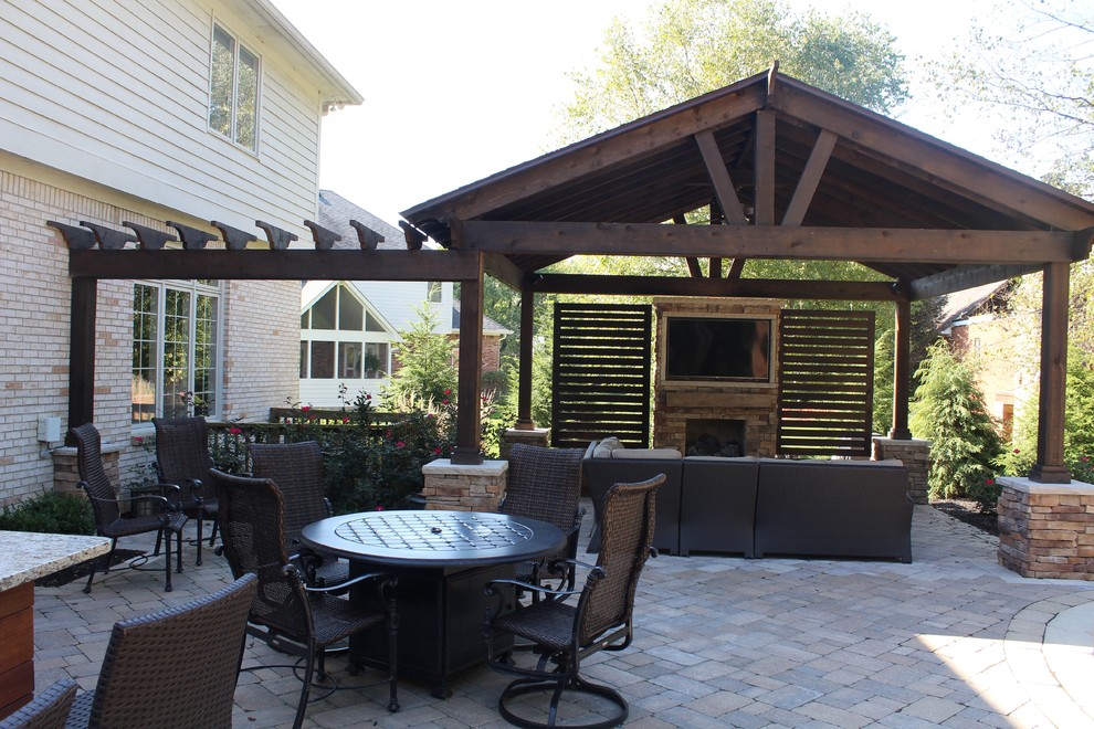 Design ideas for a mid-sized traditional backyard patio in Indianapolis with a fire feature, brick pavers and a gazebo/cabana.