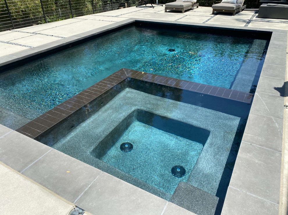 Hot tub - small backyard concrete paver and rectangular natural hot tub idea