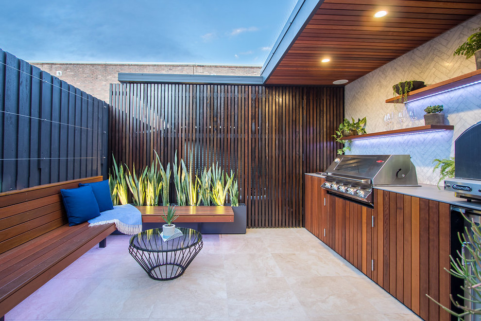 This is an example of a small contemporary patio in Sydney with a roof extension.