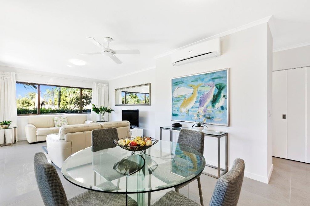 This is an example of a mid-sized contemporary open concept living room in Sunshine Coast with white walls, porcelain floors and grey floor.