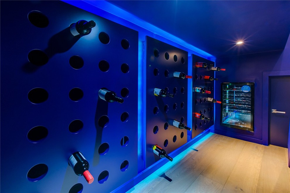 Design ideas for a contemporary wine cellar in Other with light hardwood floors and beige floor.