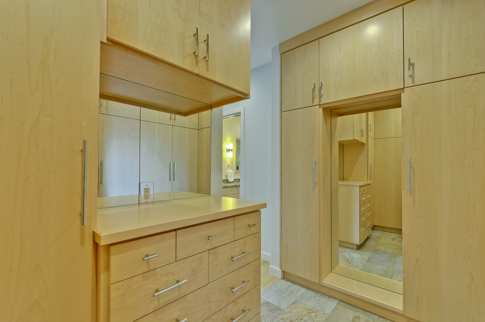 Photo of a large midcentury gender-neutral dressing room in San Francisco with flat-panel cabinets, light wood cabinets, slate floors and beige floor.