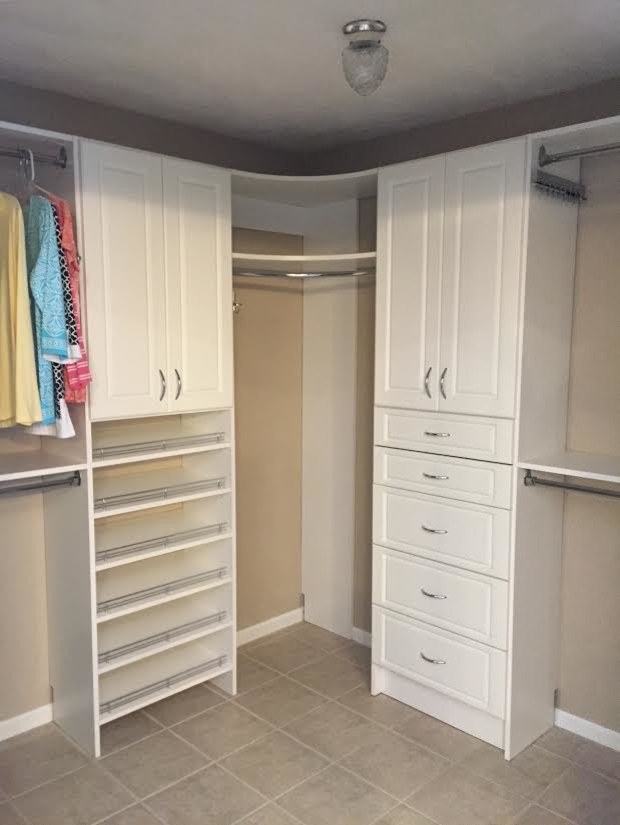 Inspiration for a large modern gender-neutral walk-in wardrobe in Huntington with raised-panel cabinets, white cabinets, laminate floors and grey floor.