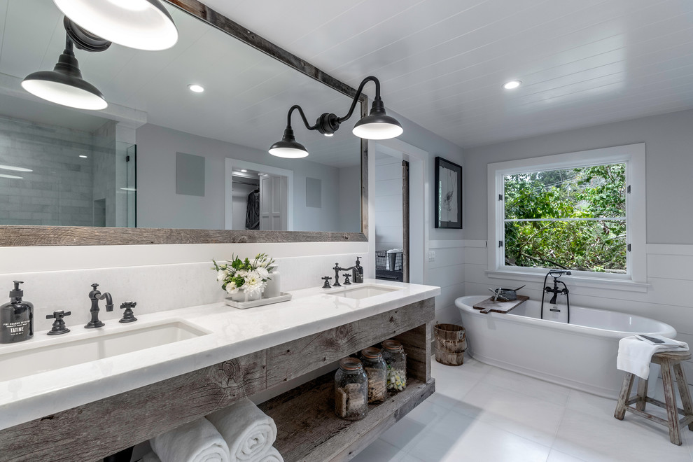 Country master bathroom in Orange County with open cabinets, distressed cabinets, a freestanding tub, grey walls, an undermount sink, white floor and white benchtops.