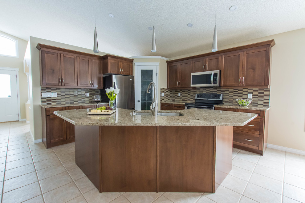 Mid-sized transitional l-shaped ceramic tile and beige floor eat-in kitchen photo in Edmonton with a double-bowl sink, shaker cabinets, brown cabinets, quartz countertops, beige backsplash, glass tile backsplash, stainless steel appliances and an island