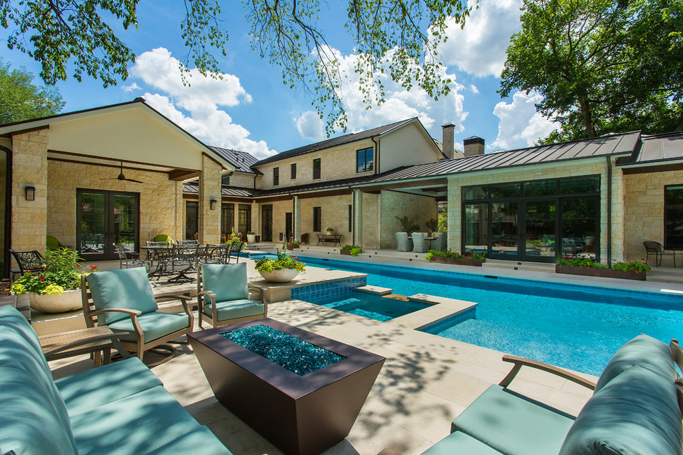 Large transitional backyard rectangular lap pool in Dallas with natural stone pavers.