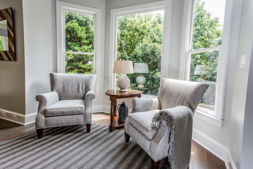 Photo of a small transitional formal open concept living room in Charlotte with grey walls, medium hardwood floors, no fireplace, no tv and brown floor.