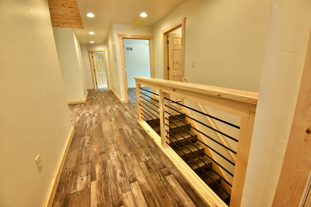 Mid-sized country hallway in Other with white walls, medium hardwood floors and brown floor.