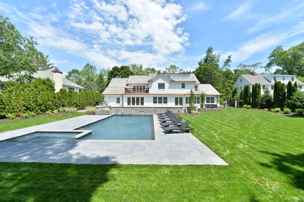 Hot tub - large transitional backyard stone and rectangular lap hot tub idea in New York