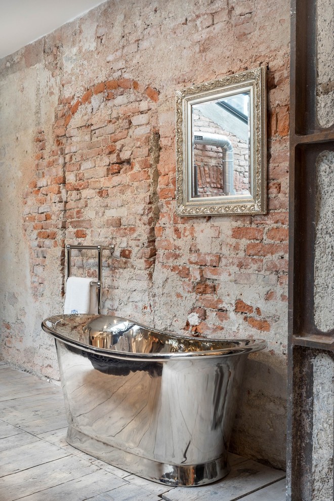 Design ideas for a mid-sized industrial 3/4 bathroom in Munich with a freestanding tub, blue tile, ceramic tile, a console sink, a shower/bathtub combo, a two-piece toilet, red walls, light hardwood floors, solid surface benchtops and grey floor.