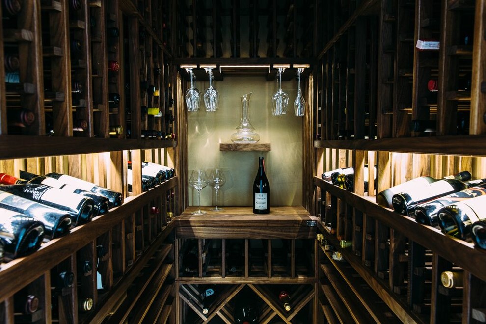 Small transitional wine cellar in Los Angeles with storage racks and marble floors.