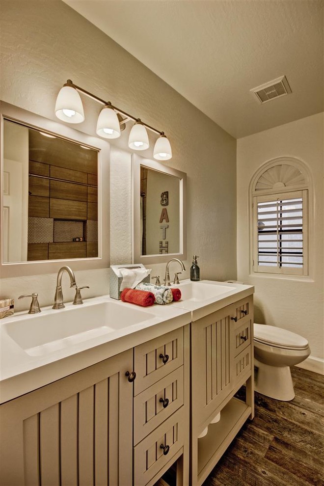 Design ideas for a transitional kids bathroom in Phoenix with an integrated sink, furniture-like cabinets, grey cabinets, engineered quartz benchtops, an alcove tub, a shower/bathtub combo, a two-piece toilet, beige tile, porcelain tile, white walls and porcelain floors.