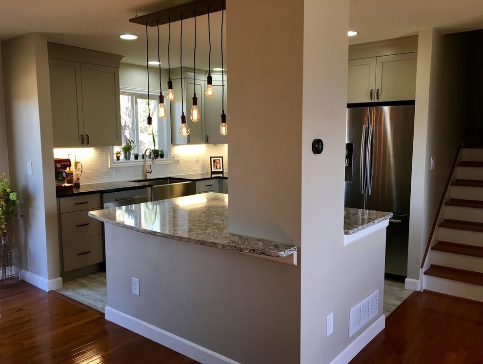 This is an example of a mid-sized country l-shaped separate kitchen in Denver with a farmhouse sink, shaker cabinets, beige cabinets, quartz benchtops, white splashback, stainless steel appliances, vinyl floors, with island, subway tile splashback and grey floor.