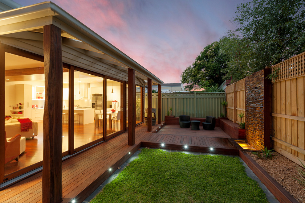 Inspiration for a mid-sized modern backyard patio in Melbourne with decking and no cover.