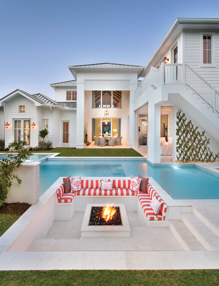Design ideas for an expansive beach style backyard patio in Miami with a fire feature.