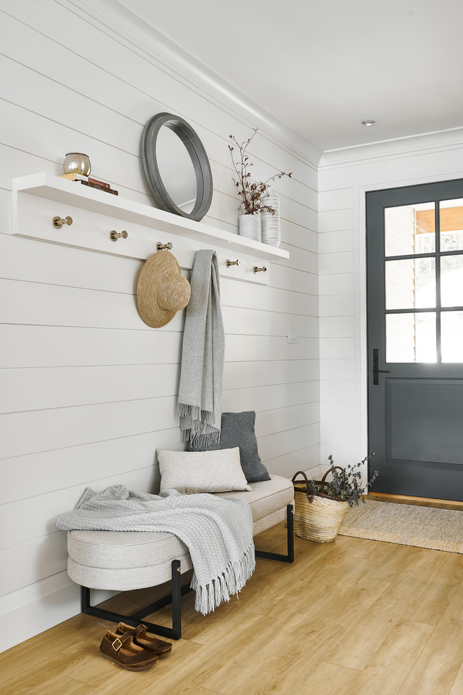 Photo of a small transitional front door in Vancouver with white walls, vinyl floors, a single front door, a gray front door and beige floor.