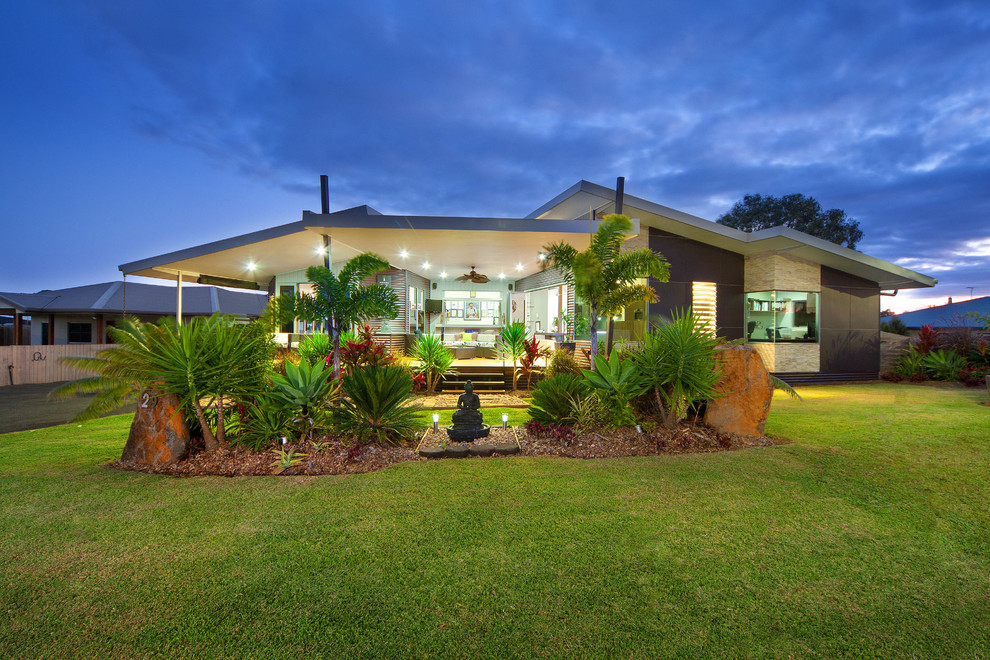 This is an example of a contemporary one-storey exterior in Cairns with mixed siding.