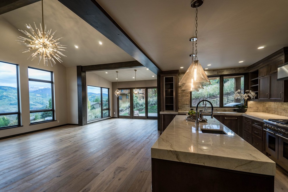 Eat-in kitchen - mid-sized transitional l-shaped light wood floor eat-in kitchen idea in Denver with an undermount sink, shaker cabinets, medium tone wood cabinets, marble countertops, multicolored backsplash, stone tile backsplash, stainless steel appliances and an island