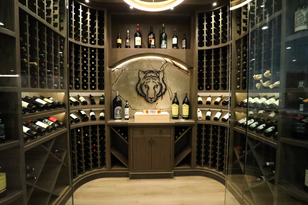 Inspiration for a mid-sized transitional light wood floor wine cellar remodel in Other
