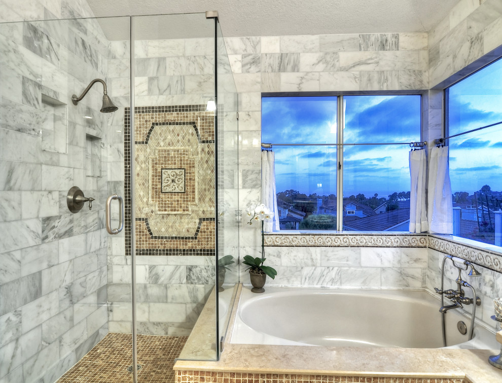 Design ideas for a large mediterranean master bathroom in Orange County with a hot tub, marble, travertine floors, limestone benchtops, beige floor, a hinged shower door, beige benchtops, a corner shower and gray tile.