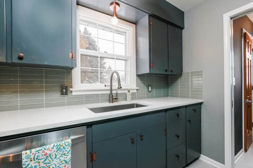 Design ideas for a small midcentury u-shaped eat-in kitchen in Grand Rapids with an undermount sink, flat-panel cabinets, grey cabinets, quartz benchtops, grey splashback, glass tile splashback, stainless steel appliances, vinyl floors, a peninsula, white floor and white benchtop.