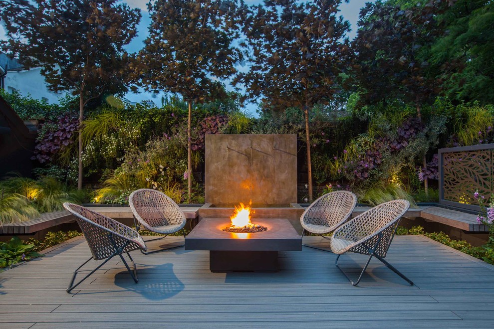 Inspiration for a large contemporary backyard patio in Surrey with a fire feature, decking and no cover.