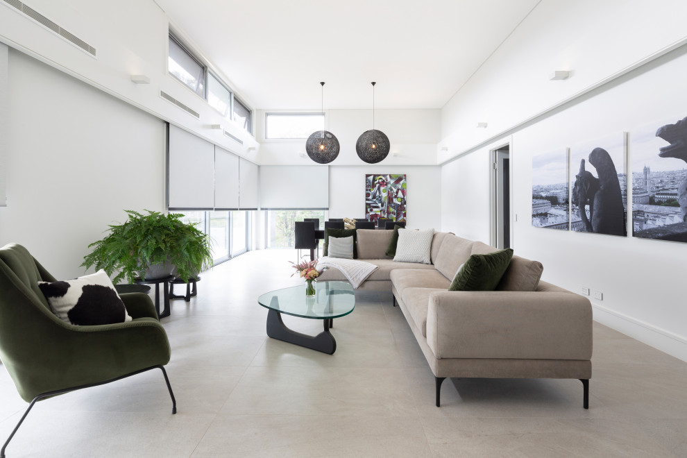 Contemporary living room in Canberra - Queanbeyan with white walls and grey floor.