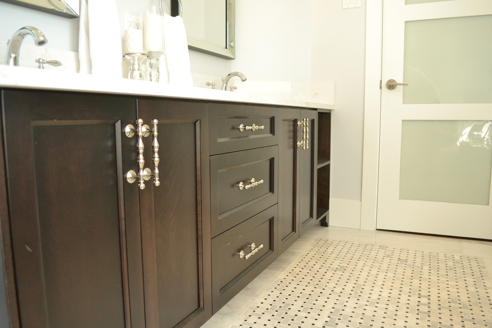 This is an example of a large traditional master bathroom in Vancouver with an undermount sink, shaker cabinets, dark wood cabinets, marble benchtops, a drop-in tub, a shower/bathtub combo, a one-piece toilet, white tile, porcelain tile, grey walls and mosaic tile floors.