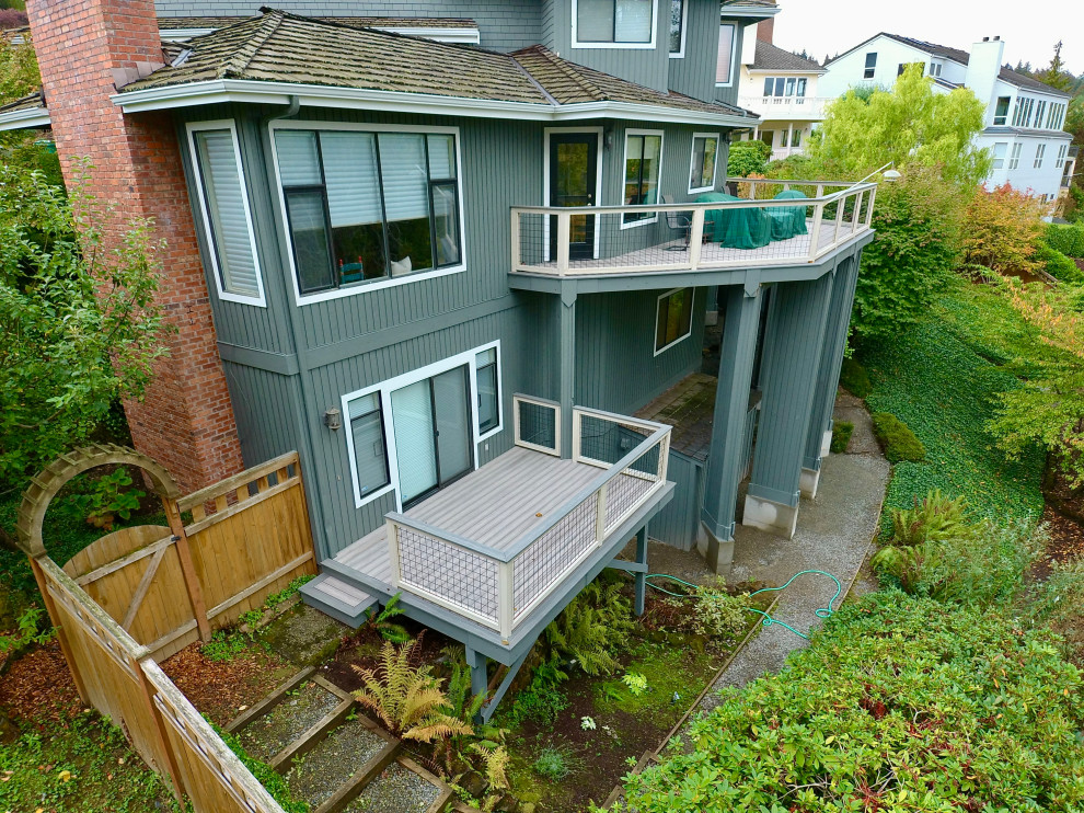 Large minimalist backyard mixed material railing deck photo in Seattle