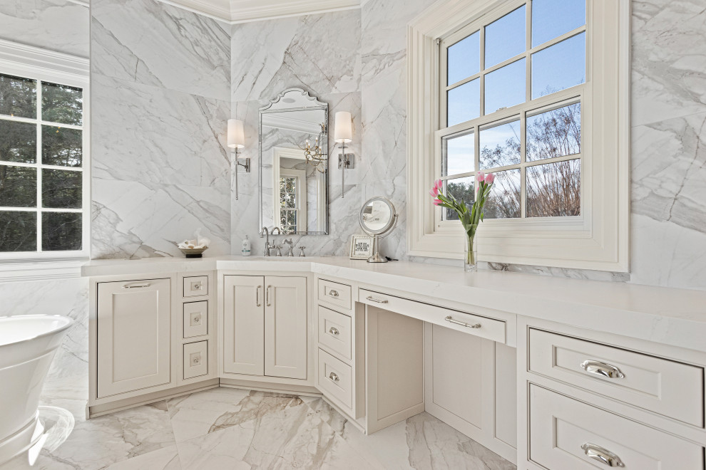 This is an example of a traditional bathroom in DC Metro with beaded inset cabinets, white cabinets, a freestanding tub, marble, engineered quartz benchtops and a hinged shower door.