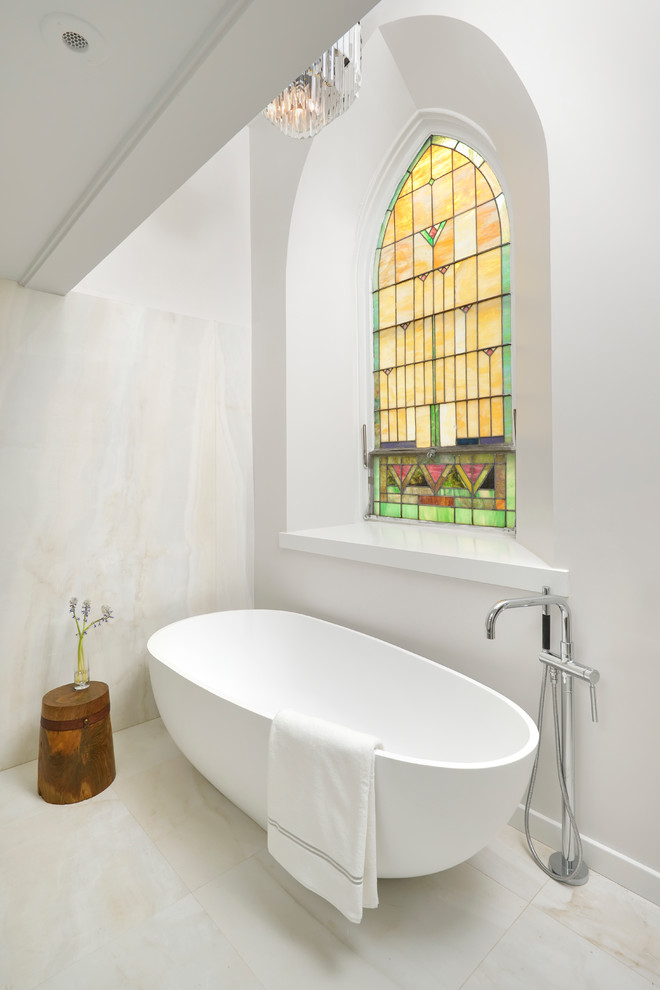 Inspiration for a contemporary bathroom in Chicago with a freestanding tub and white walls.