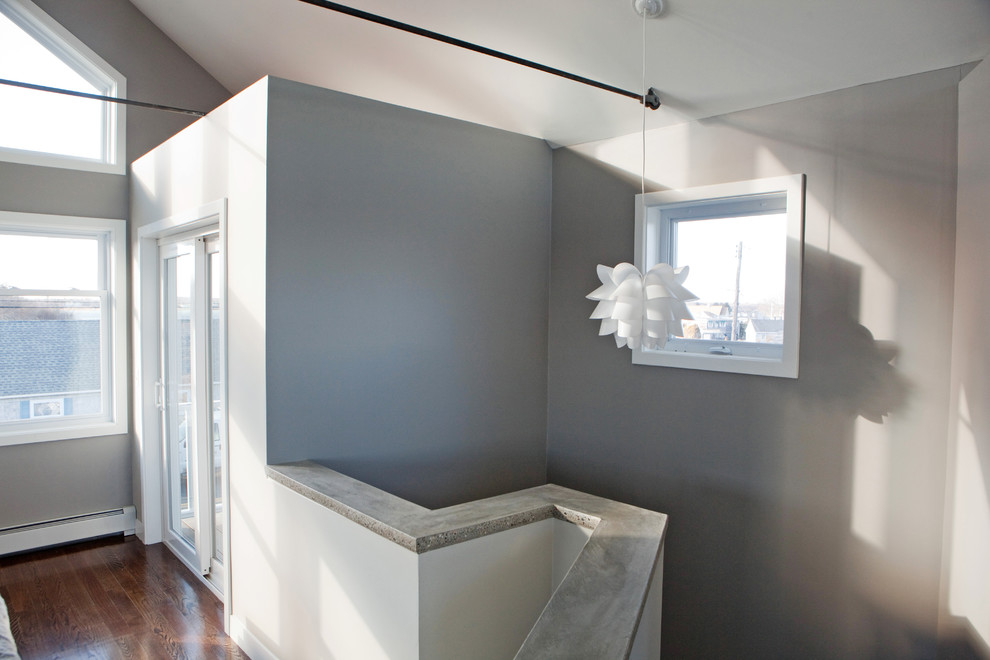 Mid-sized contemporary hallway in Providence with grey walls and medium hardwood floors.