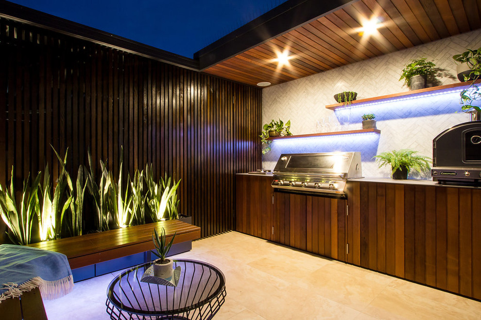 Photo of a small contemporary patio in Sydney with a roof extension.
