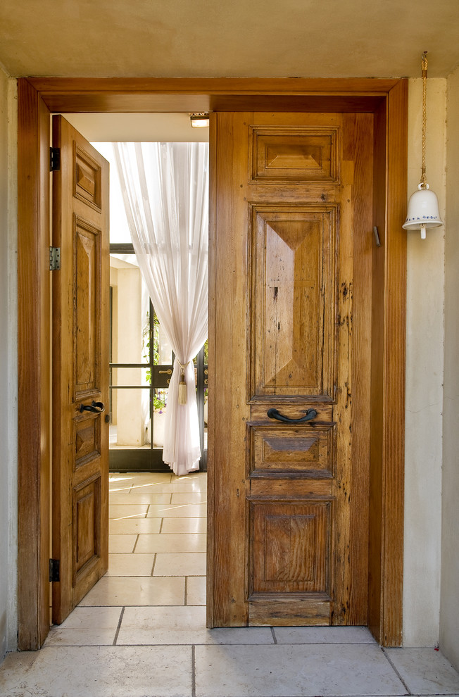 This is an example of a country front door in Tel Aviv with a double front door and a medium wood front door.