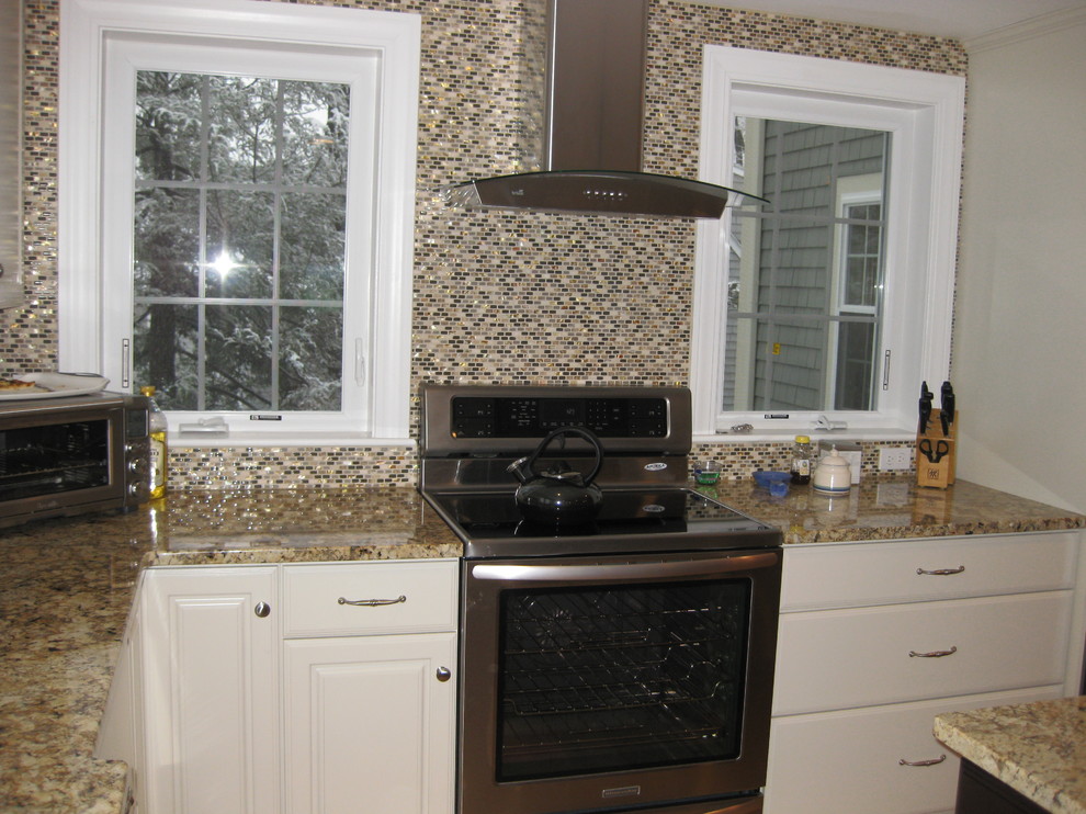 Inspiration for a transitional l-shaped light wood floor eat-in kitchen remodel in Boston with raised-panel cabinets, white cabinets, granite countertops, beige backsplash, stainless steel appliances, an undermount sink, ceramic backsplash and an island