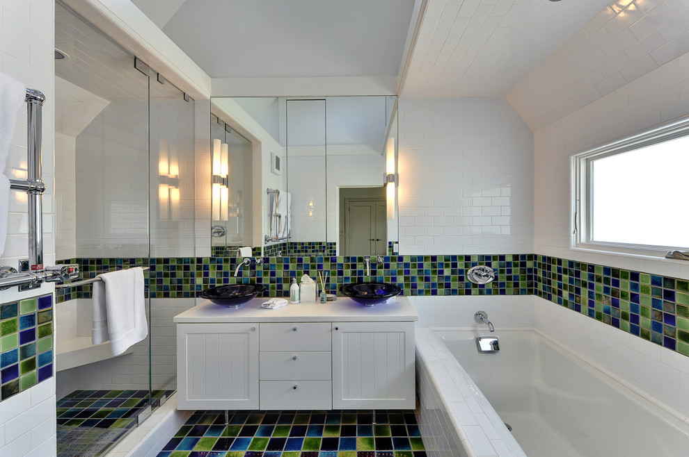 Photo of a beach style bathroom in Los Angeles with a vessel sink, recessed-panel cabinets, white cabinets, an alcove tub, an alcove shower, multi-coloured tile and mosaic tile.