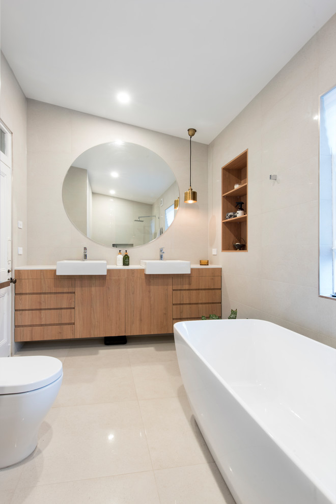 Large modern master bathroom in Newcastle - Maitland with a freestanding tub and a drop-in sink.