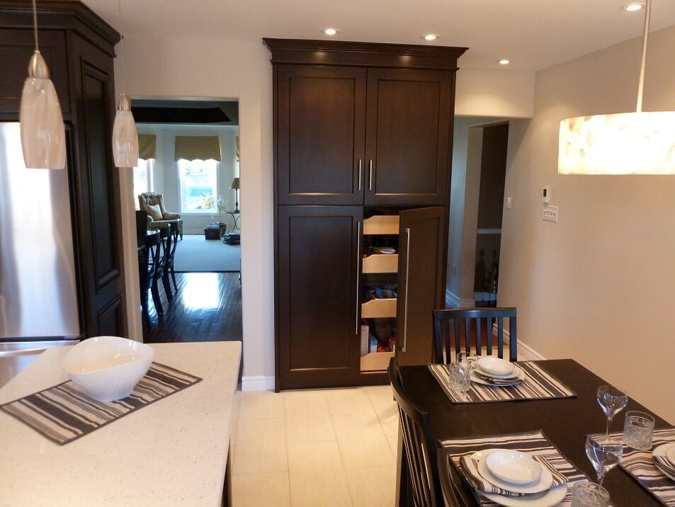 Transitional porcelain tile and beige floor eat-in kitchen photo in Toronto with a double-bowl sink, shaker cabinets, dark wood cabinets, quartz countertops, white backsplash, subway tile backsplash, stainless steel appliances and white countertops