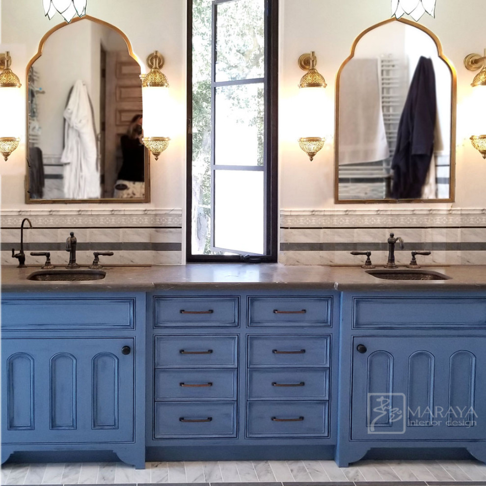 Стильный дизайн: большая главная ванная комната в средиземноморском стиле с фасадами с утопленной филенкой, синими фасадами, отдельно стоящей ванной, душем в нише, белой плиткой, мраморной плиткой, серыми стенами, мраморным полом, врезной раковиной, мраморной столешницей, серым полом, душем с распашными дверями, серой столешницей, тумбой под две раковины, встроенной тумбой и панелями на стенах - последний тренд