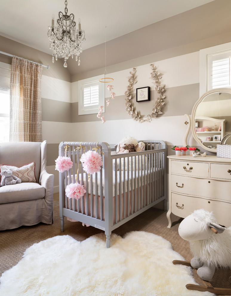 Photo of a mid-sized country nursery for girls in Denver with multi-coloured walls, carpet and beige floor.