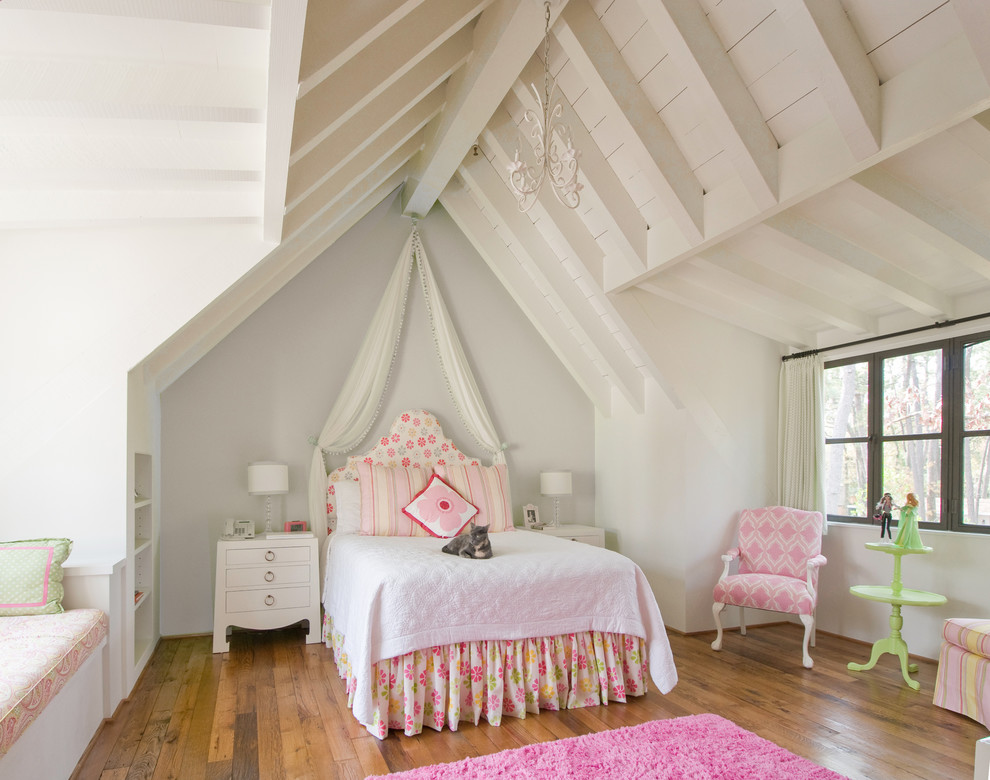 This is an example of a country kids' bedroom for girls in Houston with grey walls, medium hardwood floors and brown floor.