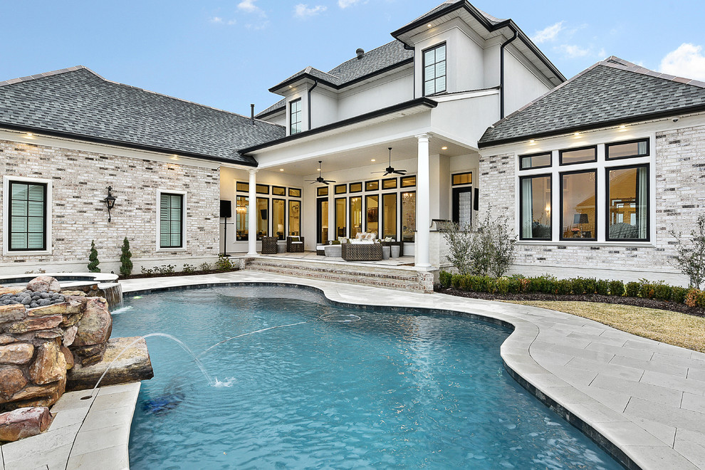 Design ideas for a traditional backyard custom-shaped pool in New Orleans with a water feature.
