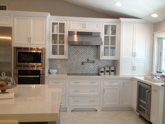 Mid-sized transitional galley separate kitchen in Miami with an undermount sink, beaded inset cabinets, white cabinets, blue splashback, glass tile splashback, stainless steel appliances and with island.