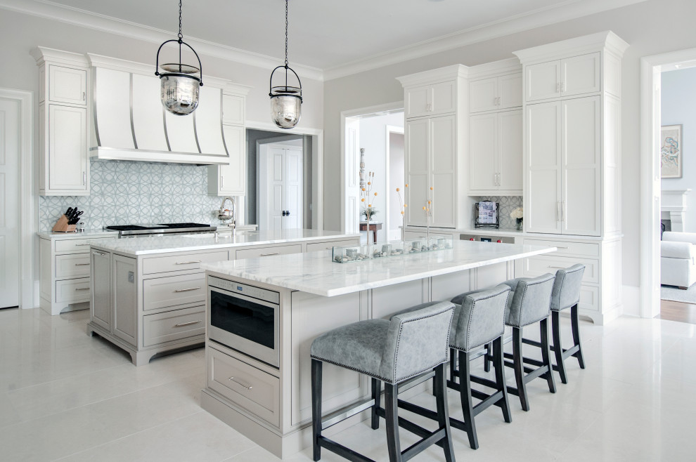 Design ideas for an expansive transitional u-shaped eat-in kitchen in Nashville with an undermount sink, beaded inset cabinets, white cabinets, quartzite benchtops, white splashback, marble splashback, stainless steel appliances, marble floors, multiple islands, white floor and white benchtop.
