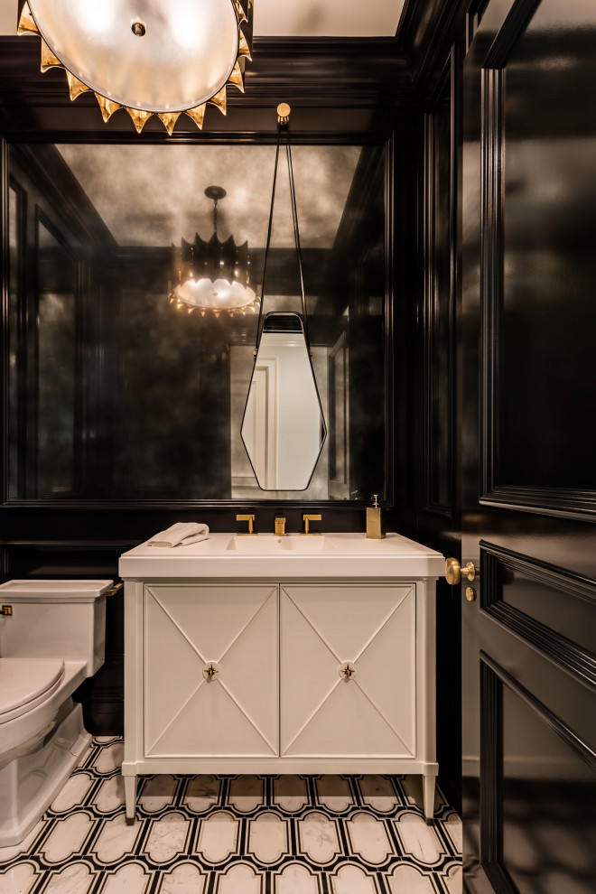 Photo of a mid-sized transitional powder room in Other with furniture-like cabinets, white cabinets, a one-piece toilet, black walls, cement tiles, an integrated sink, engineered quartz benchtops, multi-coloured floor and white benchtops.