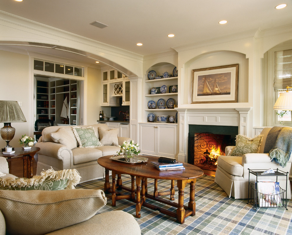 Inspiration for a mid-sized traditional enclosed living room in Providence with white walls, a standard fireplace and a wood fireplace surround.