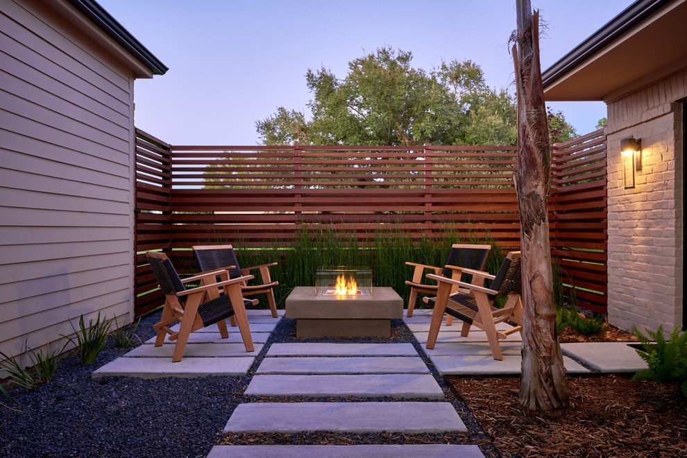 Photo of a small contemporary backyard patio in Houston with a fire feature and no cover.