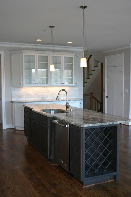 Inspiration for a large transitional u-shaped dark wood floor eat-in kitchen remodel in Baltimore with a double-bowl sink, raised-panel cabinets, light wood cabinets, granite countertops, black backsplash, stainless steel appliances and no island