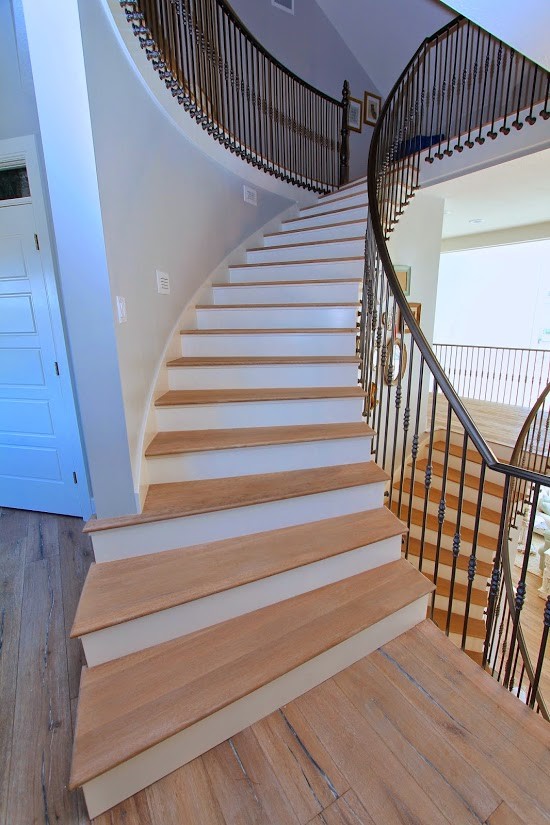 Inspiration for an expansive country wood curved staircase in Salt Lake City with wood risers.