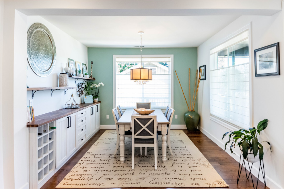 This is an example of a mid-sized transitional separate dining room in Seattle with green walls, medium hardwood floors, brown floor and no fireplace.